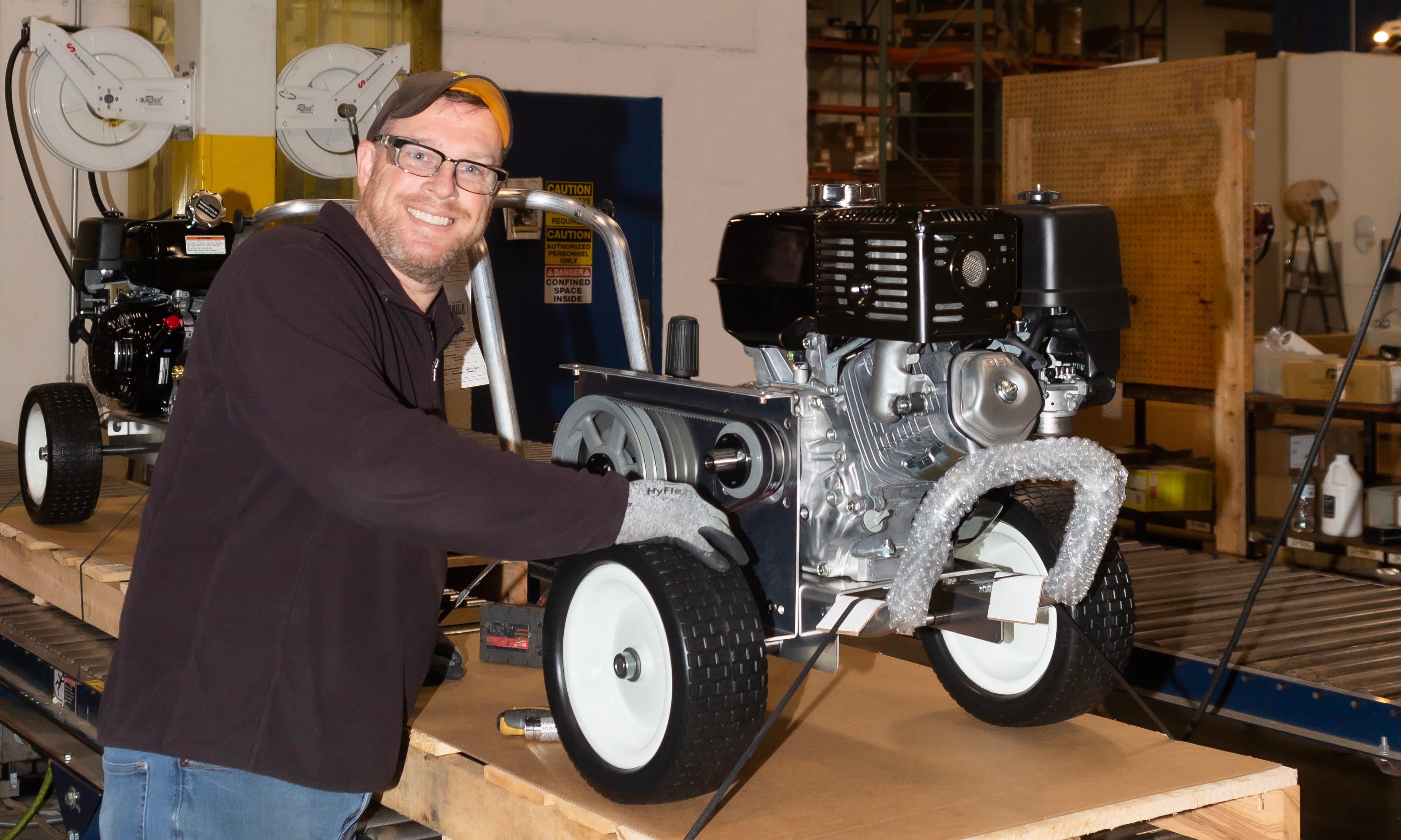 Man standing next to Mi-T-M Equipment